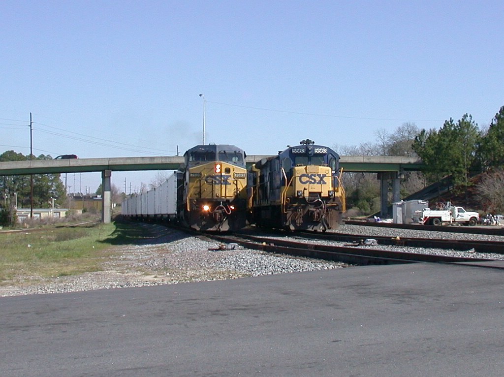 CSX 7693 with brand new hoppers from HOG yard passing local power